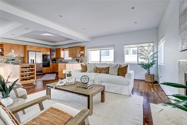 602 N Juanita Ave Unit A, Redondo Beach, CA 90277 - living room with a tray ceiling, dark wood-style floors, and baseboards