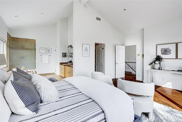 602 N Juanita Ave Unit A, Redondo Beach, CA 90277 - bedroom featuring high vaulted ceiling, light wood-type flooring, baseboards, and connected bathroom