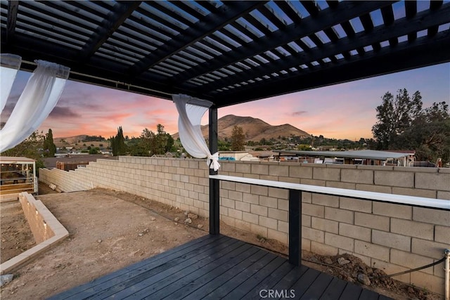 5080 Pinto Pl, Norco, CA 92860 - deck at dusk featuring a mountain view, a fenced backyard, and a pergola