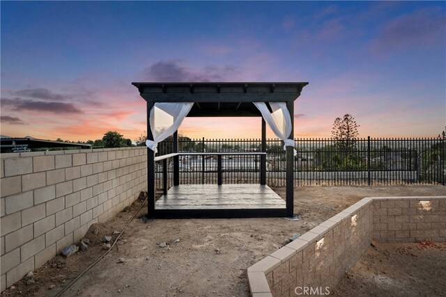 5080 Pinto Pl, Norco, CA 92860 - yard at dusk with a fenced backyard and a deck
