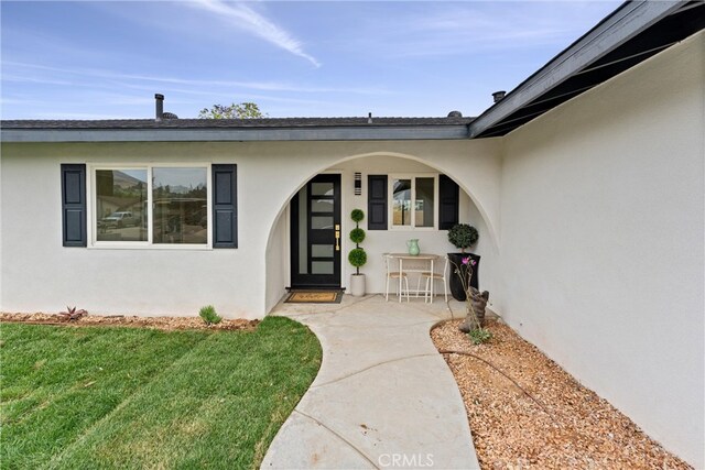 5080 Pinto Pl, Norco, CA 92860 - view of exterior entry with stucco siding and a yard