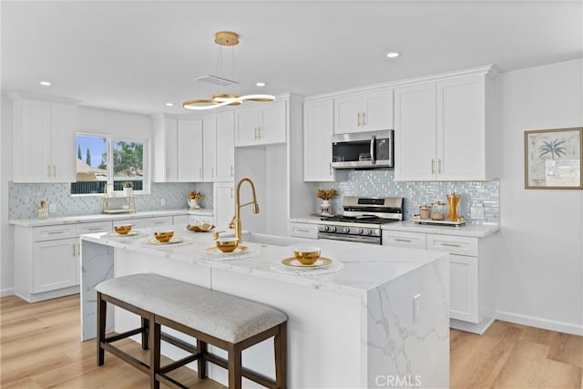 5080 Pinto Pl, Norco, CA 92860 - kitchen featuring appliances with stainless steel finishes, a sink, white cabinetry, light wood-style floors, and recessed lighting