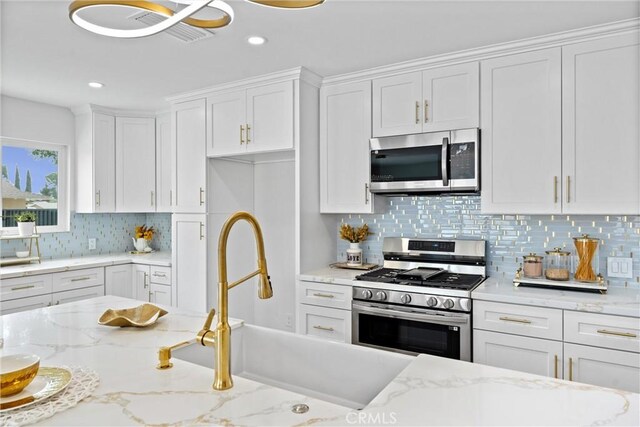 5080 Pinto Pl, Norco, CA 92860 - kitchen featuring appliances with stainless steel finishes, white cabinetry, tasteful backsplash, recessed lighting, and light stone counters