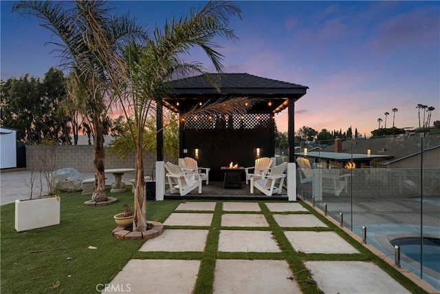 5080 Pinto Pl, Norco, CA 92860 - patio terrace at dusk with a gazebo, an outdoor fire pit, and a patio area