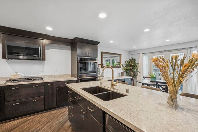 3404 Oak Cliff Dr Unit 8, Fallbrook, CA 92028 - kitchen with appliances with stainless steel finishes, a sink, dark wood-style floors, recessed lighting, and light stone counters