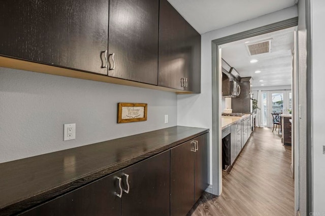 3404 Oak Cliff Dr Unit 8, Fallbrook, CA 92028 - kitchen with light wood-style flooring, dark countertops, recessed lighting, and dark brown cabinetry