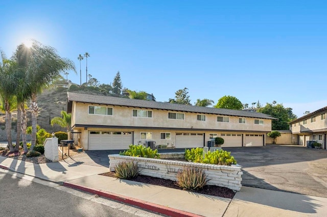 3404 Oak Cliff Dr Unit 8, Fallbrook, CA 92028 - multi unit property with stucco siding, asphalt driveway, an attached garage, and central AC unit