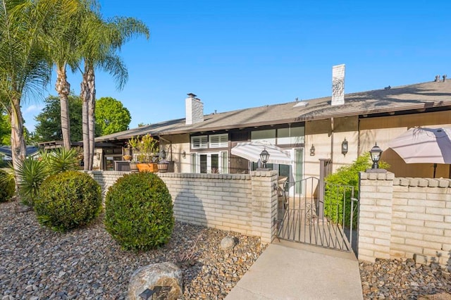 3404 Oak Cliff Dr Unit 8, Fallbrook, CA 92028 - view of front of house with a gate and a chimney