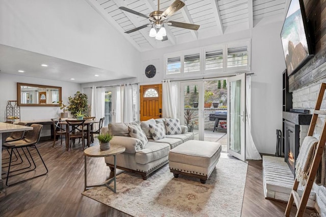 3404 Oak Cliff Dr Unit 8, Fallbrook, CA 92028 - living area featuring high vaulted ceiling, a fireplace, a ceiling fan, dark wood-type flooring, and wood ceiling with exposed beams
