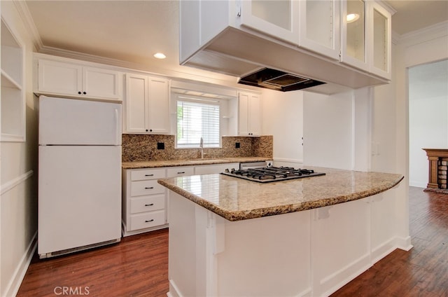 9341 Grand Dr, Huntington Beach, CA 92646 - kitchen with freestanding refrigerator, a sink, dark wood-style flooring, ornamental molding, and white cabinets