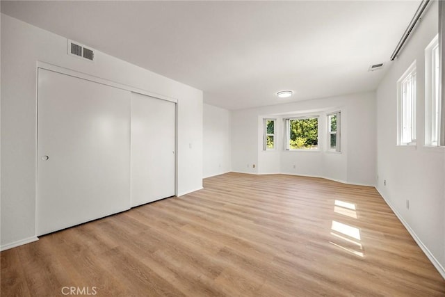 915 W Solano St, Upland, CA 91784 - unfurnished bedroom with light wood-style floors and a closet