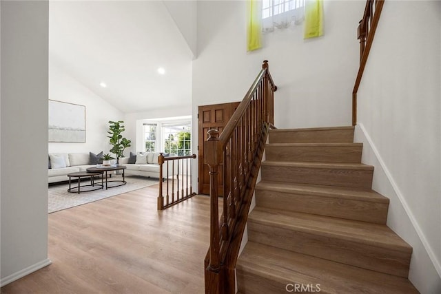 915 W Solano St, Upland, CA 91784 - stairway with wood finished floors, high vaulted ceiling, and recessed lighting