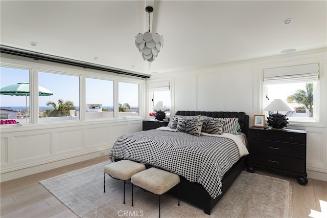 1110 Kings Rd, Newport Beach, CA 92663 - bedroom featuring a decorative wall, light wood-style flooring, and multiple windows