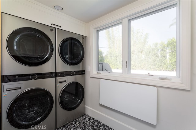 1110 Kings Rd, Newport Beach, CA 92663 - laundry room featuring estacked washer and dryer, baseboards, and healthy amount of natural light