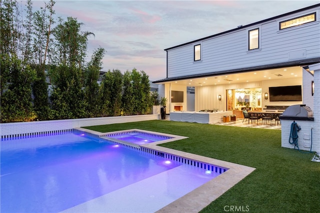 1110 Kings Rd, Newport Beach, CA 92663 - rear view of house with a lawn, an outdoor pool, outdoor lounge area, a patio area, and an in-ground hot tub