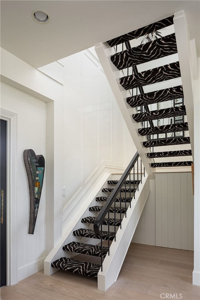 1110 Kings Rd, Newport Beach, CA 92663 - staircase featuring wood finished floors and recessed lighting