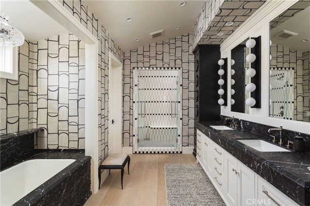 1110 Kings Rd, Newport Beach, CA 92663 - bathroom featuring double vanity, wood finished floors, a bath, and lofted ceiling