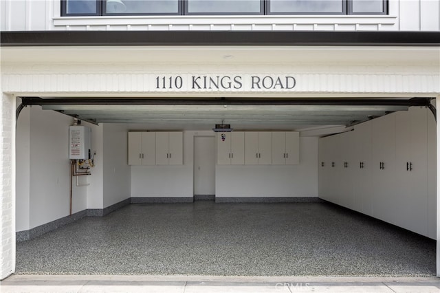 1110 Kings Rd, Newport Beach, CA 92663 - garage with water heater and a garage door opener