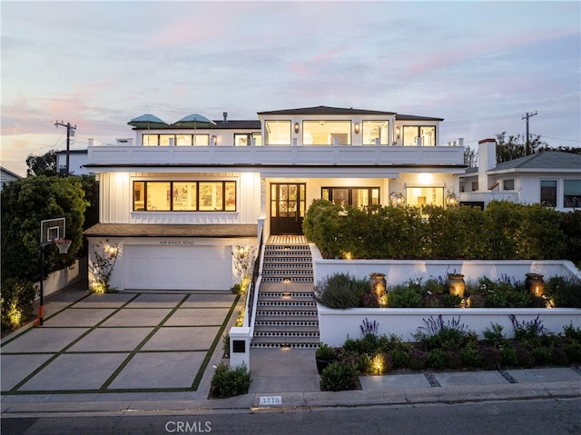 1110 Kings Rd, Newport Beach, CA 92663 - modern home featuring an attached garage, driveway, and stairs