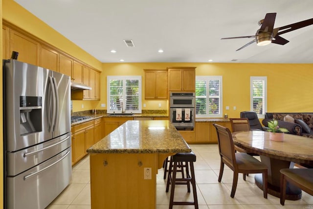 907 Rockwell Springs Ct, Escondido, CA 92025 - kitchen featuring stainless steel appliances, a breakfast bar, a kitchen island, healthy amount of natural light, and recessed lighting