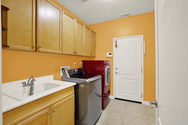 907 Rockwell Springs Ct, Escondido, CA 92025 - washroom with cabinet space, separate washer and dryer, light tile patterned floors, and baseboards