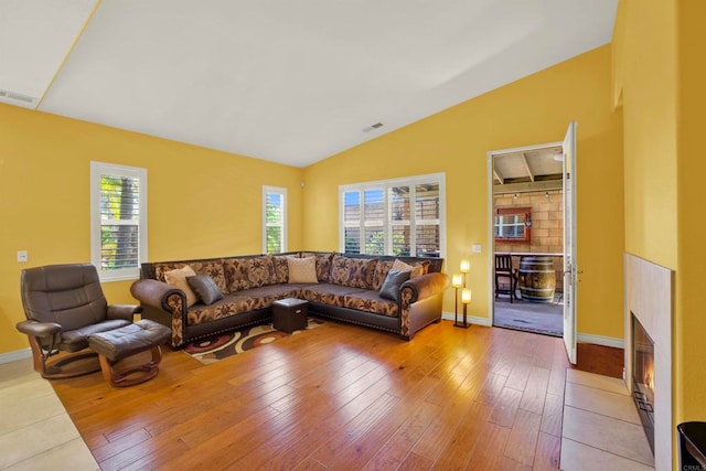 907 Rockwell Springs Ct, Escondido, CA 92025 - living room with lofted ceiling, a fireplace with flush hearth, wood-type flooring, and baseboards