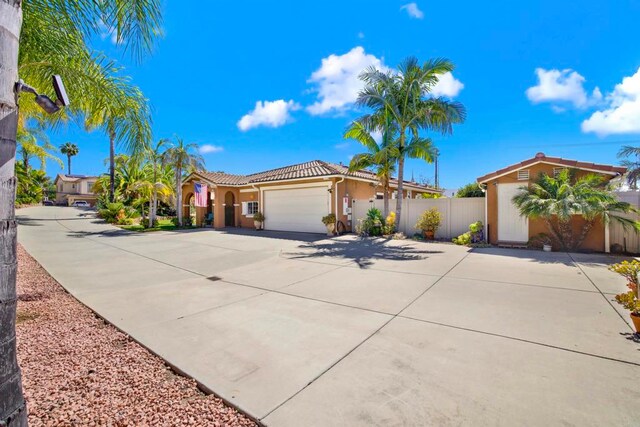 907 Rockwell Springs Ct, Escondido, CA 92025 - mediterranean / spanish-style house with concrete driveway, stucco siding, an attached garage, and a tile roof