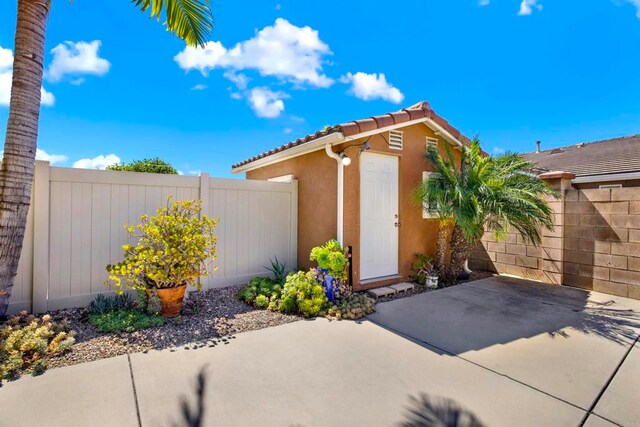 907 Rockwell Springs Ct, Escondido, CA 92025 - property entrance with a patio, a tiled roof, and stucco siding