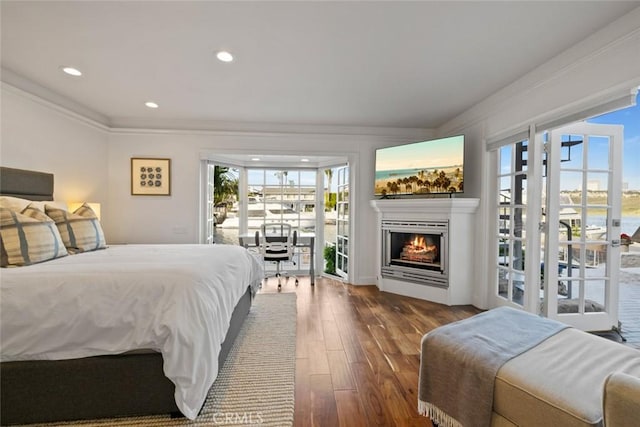 218 Evening Star Ln, Newport Beach, CA 92660 - bedroom featuring access to exterior, ornamental molding, dark wood-type flooring, a lit fireplace, and recessed lighting