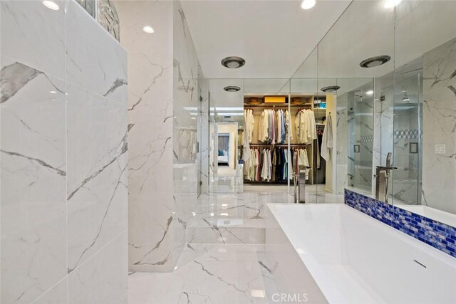218 Evening Star Ln, Newport Beach, CA 92660 - full bathroom featuring a marble finish shower, a freestanding tub, a spacious closet, and marble tiled flooring