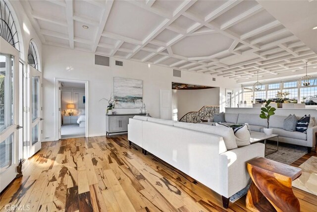 218 Evening Star Ln, Newport Beach, CA 92660 - living room featuring coffered ceiling, hardwood / wood-style floors, beam ceiling, and french doors