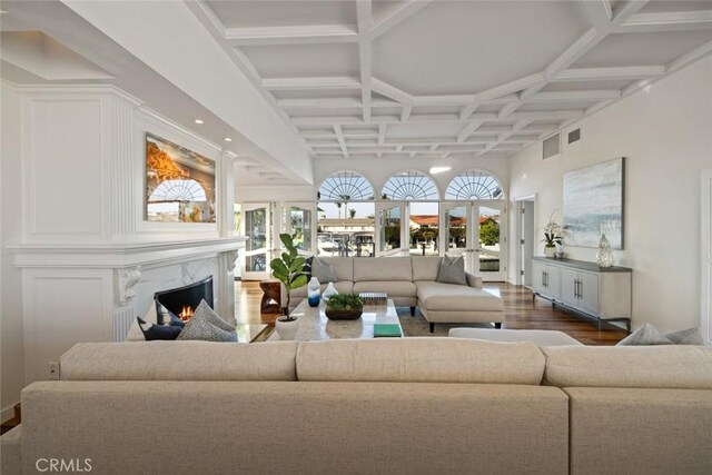 218 Evening Star Ln, Newport Beach, CA 92660 - living room with coffered ceiling, wood finished floors, a premium fireplace, a towering ceiling, and beamed ceiling