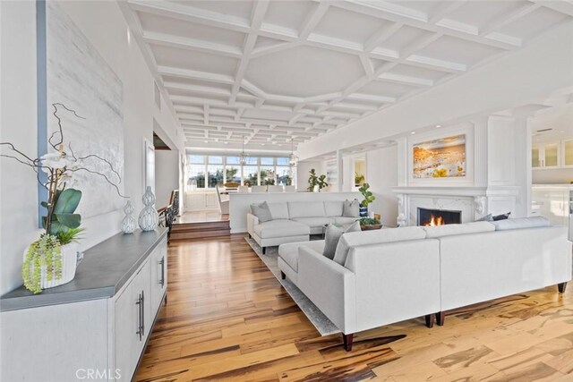 218 Evening Star Ln, Newport Beach, CA 92660 - living area with coffered ceiling, light wood-style flooring, a high end fireplace, and beam ceiling
