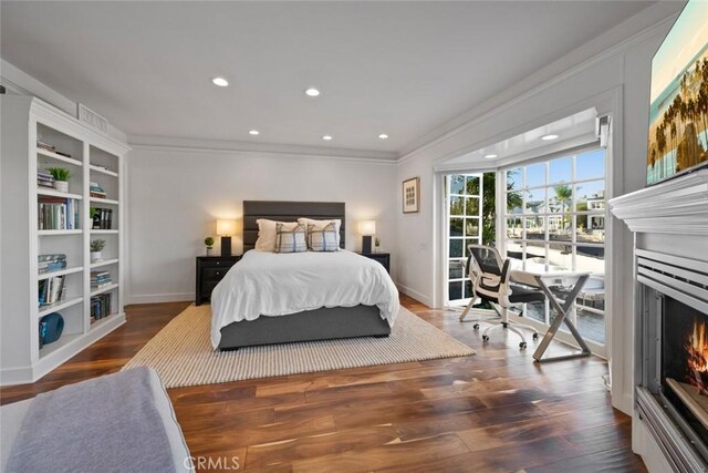 218 Evening Star Ln, Newport Beach, CA 92660 - bedroom with a warm lit fireplace, baseboards, wood finished floors, crown molding, and access to exterior