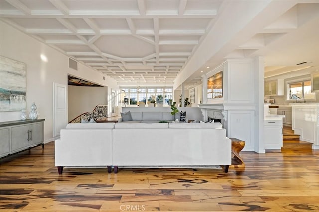 218 Evening Star Ln, Newport Beach, CA 92660 - living area featuring wood-type flooring, coffered ceiling, a fireplace, and beamed ceiling