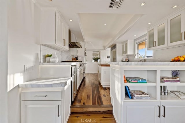 218 Evening Star Ln, Newport Beach, CA 92660 - kitchen with wood finished floors, white cabinetry, wall chimney range hood, light countertops, and backsplash