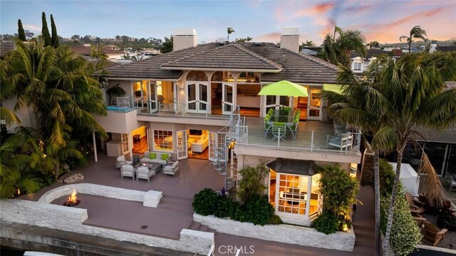 218 Evening Star Ln, Newport Beach, CA 92660 - back of house with an outdoor living space with a fire pit, a chimney, a patio, and stairway