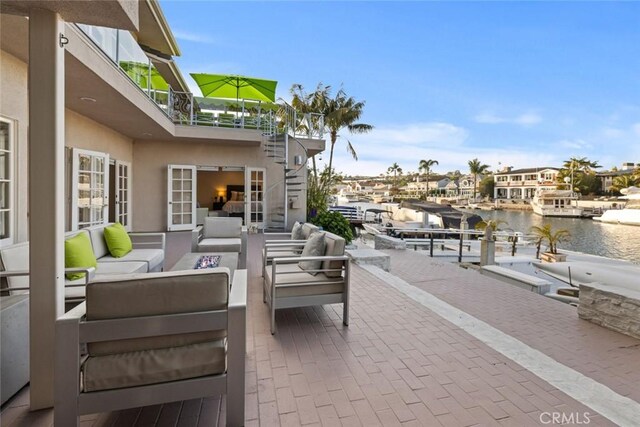 218 Evening Star Ln, Newport Beach, CA 92660 - view of patio / terrace with an outdoor hangout area, a balcony, a water view, and a boat dock
