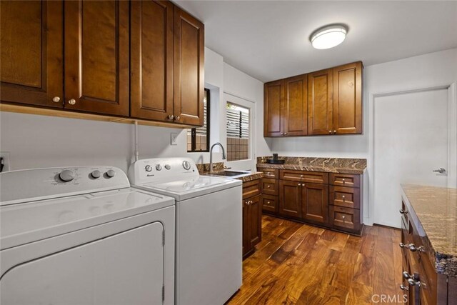 218 Evening Star Ln, Newport Beach, CA 92660 - laundry room featuring separate washer and dryer, dark wood-style flooring, and cabinet space