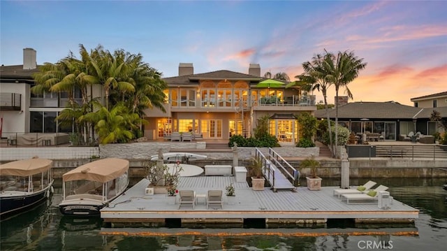 218 Evening Star Ln, Newport Beach, CA 92660 - back of property with a balcony, a water view, and a chimney