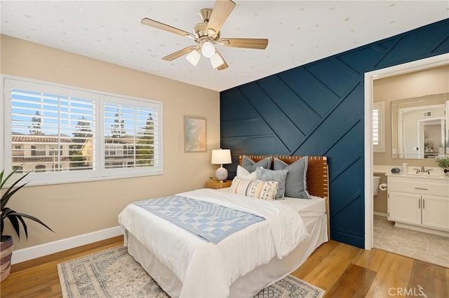 24261 Ernest Johnson Cir, Yorba Linda, CA 92887 - bedroom featuring light wood-type flooring, a sink, baseboards, ensuite bathroom, and a ceiling fan