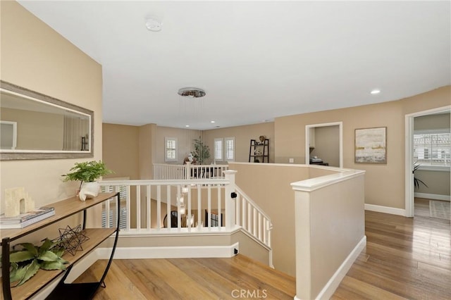 24261 Ernest Johnson Cir, Yorba Linda, CA 92887 - hall with an upstairs landing, wood finished floors, baseboards, and recessed lighting