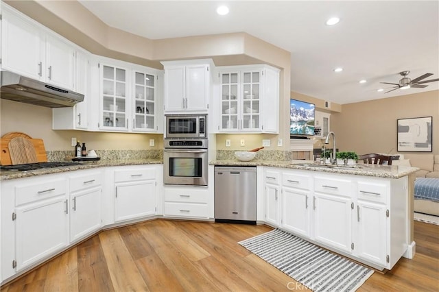 24261 Ernest Johnson Cir, Yorba Linda, CA 92887 - kitchen with appliances with stainless steel finishes, under cabinet range hood, a sink, a peninsula, and white cabinets