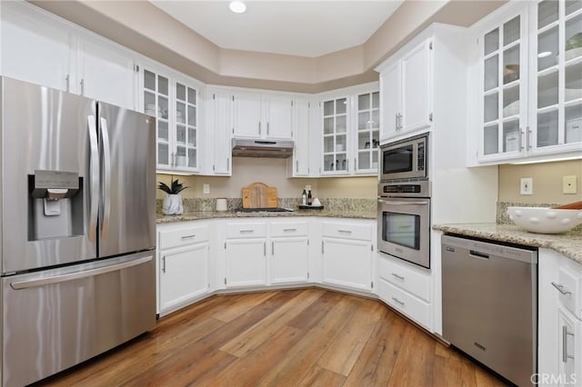 24261 Ernest Johnson Cir, Yorba Linda, CA 92887 - kitchen with appliances with stainless steel finishes, under cabinet range hood, light wood-style flooring, and white cabinets