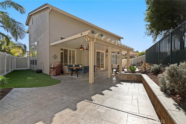 24261 Ernest Johnson Cir, Yorba Linda, CA 92887 - back of property with ceiling fan, stucco siding, a fenced backyard, and a patio