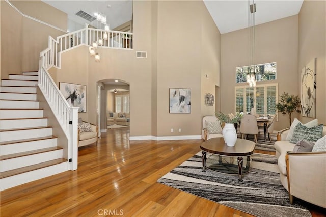 24261 Ernest Johnson Cir, Yorba Linda, CA 92887 - living area featuring a chandelier, stairway, wood finished floors, a high ceiling, and healthy amount of natural light