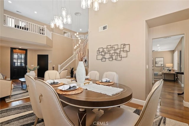 24261 Ernest Johnson Cir, Yorba Linda, CA 92887 - dining room with a chandelier, wood finished floors, baseboards, stairs, and plenty of natural light
