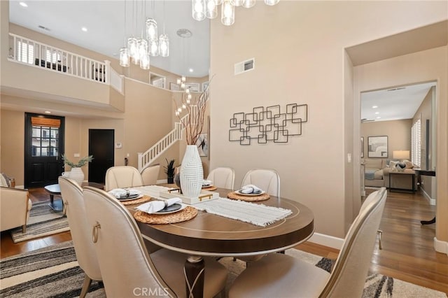 24261 Ernest Johnson Cir, Yorba Linda, CA 92887 - dining room featuring a chandelier, wood finished floors, stairs, healthy amount of natural light, and recessed lighting