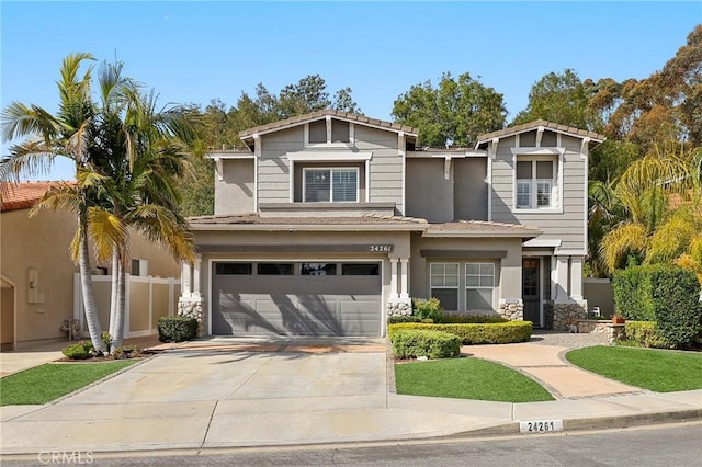 24261 Ernest Johnson Cir, Yorba Linda, CA 92887 - view of front of property featuring an attached garage, concrete driveway, stucco siding, and stone siding