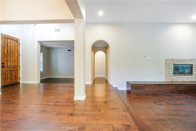 12160 Glines Ct, Tustin, CA 92782 - foyer entrance featuring wood finished floors, arched walkways, a fireplace, baseboards, and recessed lighting